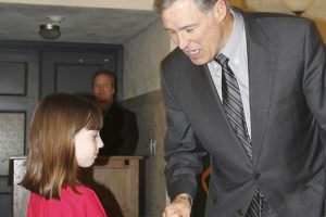 Paige Maas, a Hathaway Elementary School third-grader, shakes hands with Gov. Jay Inslee during a diabetes funding advocacy day held at the state Capitol.