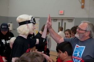 A student celebrates with a volunteer after participating in a Northwest Association of Blind Athletes goalball tournament in March, in Canby, Ore. "It is a game that requires superb hearing skills, excellent reflexes and superb mental concentration," said Billy Henry, co-founder of the NWABA. A national goalball tournament will be held June 20-22, in Vancouver.