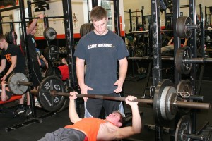 Jarrett Gregory lends a helping hand to Bobby Jacobs. Gregory started a weight lifting club at Washougal for his senior project.