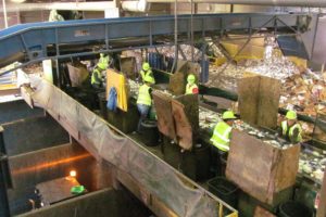 Employees sort through items at the recycling center at Waste Connections. Each one is responsible for a different commodity.