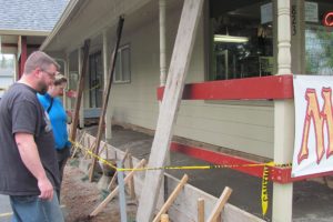 David and Rebecca Dotson, owners of Hero Support in Washougal, inspect some of the damage caused by a fire last month. The couple must come up with approximately $5,000 to pay for repairs.