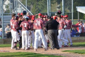 The Papermakers greet Reilly Hennessey at home plate after he hit a 3-run home run to put the finishing touches on a 14-2 victory against Skyview Monday, at Camas High School.