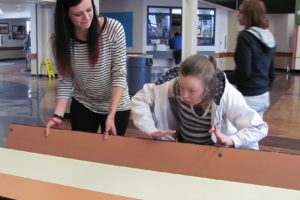 WHS senior Miranda Lynch helps a special needs student stack the lunch tables in the school commons area. "I love helping them," she said. "It is so much fun." Lynch struggled at her school in Minnesota but is now on track to graduate since transferring to WHS last spring.