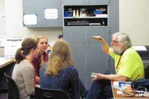 Ninth-grade students meet with Wright to discuss symposium projects. All Math, Science and Technology Magnet Program participants must complete a year-long research project. "He's very dedicated, and cares a lot about students success," said ninth-grader Anna Roche.