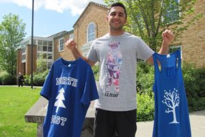 CHS senior Nitin Beri shows some examples of shirts available to purchase from his non-profit, Live Love Northwest. All proceeds benefit homeless and at-risk youth.