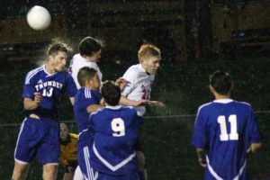 Danny Wing and Riley Brannon collide with Mountain View soccer players Friday, at Doc Harris Stadium. The Papermakers defeated the Thunder 3-0 to become league champions.