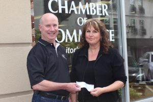 Anna Fry (right), principle secretary for the Georgia-Pacific Camas paper mill engineering department and VP Mill Manager Joe Ertolacci, recently presented a check for $3,500 to Brent Erickson (left) executive director of the Camas-Washougal Chamber of Commerce.