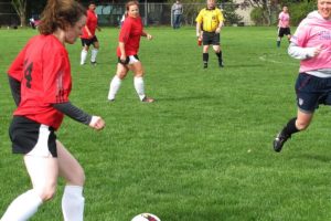 Erin Bradstreet, of Camas, moves the ball down the field, as her sister Rachel (center), of Washougal, looks on. The Bradstreets and their teammates on Passin Thru beat the team Little Indian 4-2, on April 13, at Wy'East Community Park, in Vancouver. The Lower Columbia Womens Soccer Association includes teams for women ages 30 and older.