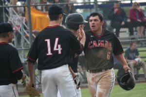 Liam Fitzpatrick gets a high five from Hunter Bruno after scoring the leading run for Camas in the eighth inning Monday, at Skyview High School. The Papermakers tacked on more runs to win 5-1.