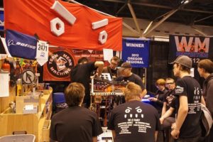 Students on the Camas-Washougal Robotics Team, known as "Team Mean Machine," make adjustments to their robot, Odd Job, during a competition. The team is made up of students from Camas, Washougal and Hockinson high schools.