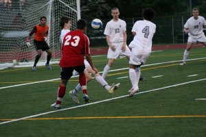 Camas forward Cameron Eyman kicks the soccer ball between three defenders and out of reach of the goalkeeper Thursday, at McKenzie Stadium. The Papermakers defeated the Union Titans 1-0 and became league champions.