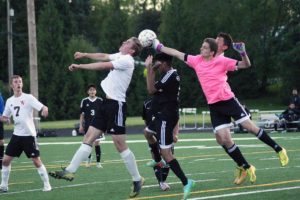 Nicholas Boylan gets his head to the soccer ball, but the Hudson's Bay goalkeeper punches it away. Washougal scored five goals in the second half to beat the Eagles 6-1 May 5, at Fishback Stadium.