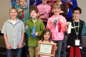 Camas students are all smiles after the recent state science fair. Pictured are front center: Dalilah Cunningham; first row from left:  Eli Burton, Ben Saunders, Alexis Williams, Jaden Le; second row from left:  George Walker, Illaria Cunningham, Mila Smook; back row from left:  Madeleine Sheppard, Emily Sheppard, Bilal Manzer, Chemay Shola. Not pictured are  Meghal Sheth, Sophie Shoemaker and Reesab Pathak.