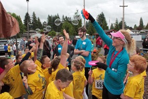 Washougal School Board member Teresa Lees keeps kids entertained with a bubble machine as they wait for their turn to run the Student Stride for Education on Saturday. According to event coordinator Stephanie Eakins, the 12th annual fundraiser, held in Fishback Stadium at Washougal High School, included 592 participants and 113 race day volunteers. Initial tallies indicate that approximately $16,000 was raised to support classroom grants to benefit students in the district's schools. The presenting sponsor was Discovery Dental. For more information, visit www.washougalschoolsfoundation.org.