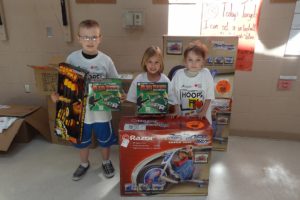 Third-grader Brian Hoff, kindergartner Addysen Case and first-grader Davlin Coburn proudly display the prizes they won for being top fundraisers during the Hoops for Heart event at Lacamas Heights Elementary School. A total of $10,925 was raised for the American Heart Association. Of that total, Coburn was the top fundraiser at $1,205. Case raised $410 and Hoff raised $270.