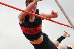 Adam Thomas soars over the bar set at 13 feet for the first time this season to earn second place in the pole vault during the 2A district track and field meet Friday, at Fishback Stadium.