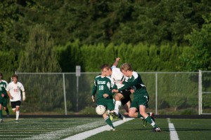 Camas forward Nate Beasley bursts through two Skyline Spartans May 14, at Doc Harris Stadium. The Papermakers beat the Spartans on penalty kicks to advance to the state quarterfinals.