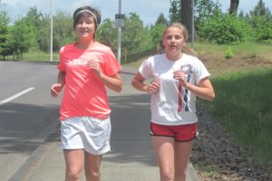 Paige McCray (left) and Lindsey Lattimer are heading into the final weeks of half-marathon training.