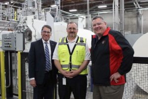 Camas City Administrator Pete Capell, Camas VP Mill Manager Joe Ertolacci and Camas Mayor Scott Higgins (left to right) tour the Camas mill's new enMotion towel rewinder, nicknamed "Ike."