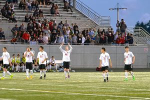 Camas High School soccer players Josh Stoller, Tyler Vela, Cayne Cardwell, Cameron Eyman, Riley Brannon, Jakob Cavin, Dominic Fewel and Lucas Ulmer look to the home crowd for support before overtime begins Wednesday, at Doc Harris Stadium.