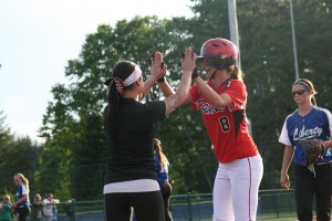 Camas senior Cali Mulholland high-fives assistant coach Ari Van Horn after her third hit of the game. The Papermakers defeated Liberty 9-5 to become one of the top eight teams in the 3A state softball tournament at the Regional Athletic Complex.