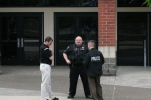 Aaron Hansen, WHS principal, confers with Sgt. Geoff Reijonen (center) and Cmdr. Allen Cook of the Washougal Police Department. The school was evacuated at approximately 10 a.m. Tuesday morning after a threatening note was found in a school restroom. The building was searched and students returned to class at approximately 11 a.m.