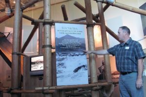 Columbia Gorge Interpretive Center Museum Director Robert Peterson said the building is designed with different elements that represent the area. Here, he stands underneath a "pithouse," replica. Inscribed is a quote from Victoria Howard, of the Clackamas Chinook.