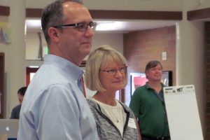 Current Washougal School District Superintendent Dawn Tarzian and her successor, Mike Stromme, address the crowd at the design symposium.