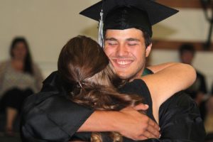 Hayes Freedom High School student Zach Hausinger hugs Principal Amy Holmes after receiving his diploma Saturday. During her speech to the crowd, Holmes described herself as passionate about the students' education. "I was fierce, you might have misjudged that as mean, about helping you make the choices that would not only get you here today, but I was fierce because you deserved to get here with incredible learning experiences, amazing memories and most importantly hope," she said. "You are smart, talented, strong-willed and powerful beyond measure."