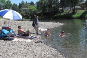 Area residents enjoyed the sun and water at the Sandy Swimming Hole, Monday. Washougal Mayor Sean Guard and others want visitors to local parks to respect the parking and littering laws.