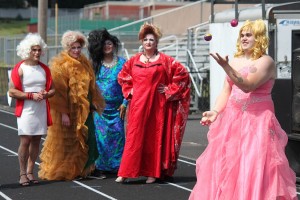 Jacob Atkinson, of Team M.A.C. (Minions Against Cancer), juggles as part of the talent segment of the "Misster Relay" pageant. It was held Saturday afternoon, during the 24-hour Relay for Life at Fishback Stadium at Washougal High School. Looking on are (right to left) Daris Freimuth, Brandon Renninger and Kamu Cheek of the Walmart Walkers, and Steven Phillips of the Wayward Women of Washougal. All told, nine men dressed up as women to raise money for the American Cancer Society.