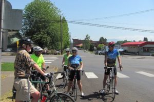 Cyclists stop near a historical house, one of the points of interest during Joseph Blanco's history rides in Camas. Cycling is becoming an increasingly popular way to spend leisure time, but it is still developing as a lifestyle.