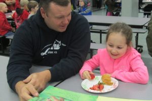 Seth Teeters and his daughter, Lela, enjoy the Books and Breakfast event at Cape Horn-Skye Elementary. It gives students and their parents a chance to read and eat together, and is one of the unique programs at the school.