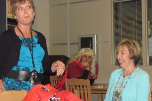 Camas High School librarian Rosemary Knapp (seated) listens to a funny story from career specialist Suzie Downs during her retirement party earlier this month. Knapp, 61, retired after 31 years with the Camas School District.