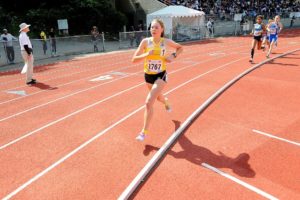 Alissa Pudlitzke surges to victory in the 1,500-meter race June 21, at the Pacific Northwest Junior Olympic Championships at Kent Meridian High School. She crossed the finish line in 4:51.04.