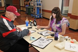 Wendell Heim created Japanese-style calligraphy with Noelle Schmidt, a sophomore at Washougal High School. Heim, a veteran of World War II and the Korean War, recently talked about his personal and military experiences with the Japanese class at WHS. "I enjoyed having him in class discussions," Schmidt said. "I learned more about the war and his old life."