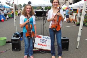 Sophia Hansen (left) and Rachel Greene played their violas at the Camas Farmer's Market last Wednesday to raise money for the Humane Society of Southwest Washington.