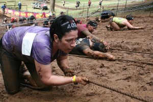 Spartans climb up Horsepower Hill using only a rope, brute strength and teamwork Saturday, at Washougal Motocross Park. The sticky and slippery mud combined with the strings of barbed wire above their heads left little room for error.