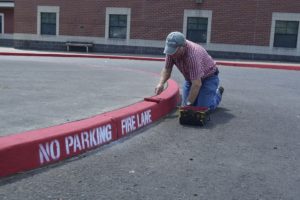 Jack Walker from the WSD Maintenance Department repaints the fire lane area at the Washougal High School parking lot. Keeping this lane available in case of an emergency is one way to increase safety.