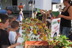 Kids give their creations one final inspection before the Camas Farmer's Market Veggie Derby last Wednesday, while others work on last minute touches. Awards were given out for most use of veggies, fastest/farthest and most creative.