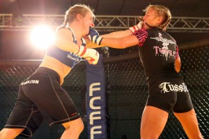 Emily Whitmore (right) throws fists with Liz Tracy during Caged at the Coast 6, in Lincoln City, Ore. Whitmore, who grew up in Washougal, will fight for the FCFF Female 125-pound championship at Rumble at the Roseland 65, Aug. 25, at the Roseland Theater, in Portland, Ore.