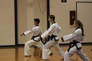 Award winners Sean Oulashin, Jordan Johnson and Miranda Dean practice correct form while doing front kicks. At the U.S. Soo Bahk Do National Festival July 19, Oulashin placed first in sparring and second in forms for his age group, Johnson and Oulashin participated in festival demonstrations, and Dean placed second in sparring.