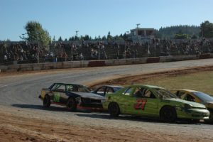 Photos by Mike Weber/For the Post-Record
Washougal's Brad Ruth (No. 10 black car on left) maneuvers around turn one of River City Speedway's quarter-mile clay oval track during the trophy dash race July 27, at the Columbia County Fairgrounds motorsports facility in St. Helens, Ore.