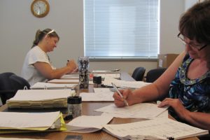 Staff members at the Camas School District transportation department prepare bus routes for the start of the school year on Tuesday, Sept. 4.