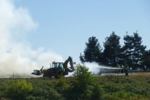 Firefighters work to extinguish a blaze after a truck carrying hay caught on fire on Aug. 20 at Highway 14 in Washougal.