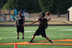 Quarterback Chase Duey delivers a pass from the orange Washougal "W." The Panthers play their first football game on the new turf at Fishback Stadium Friday, Sept. 6. Kickoff is at 7 p.m., following a ribbon cutting ceremony.