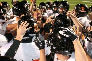 The Washougal High School football players celebrate with head coach Bob Jacobs after beating Hudson's Bay 50-0 Friday night, at Kiggins Bowl in Vancouver. The Panthers travel to Tenino Friday.