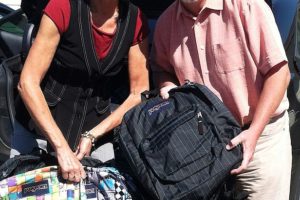 Dawn Tarzian and Mike Nerland, superintendents of the Washougal and Camas school districts, delivered 220 backpacks to school administrators to distribute to children in need.