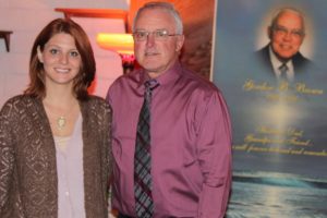 Gretel Bohn (left) is the newest addition to the staff at Brown's Funeral Home in Camas, which is owned by Ron Brown (right). The Brown family has been involved in the funeral service industry since 1965 when Ron Brown's father, the late Gordon Brown (pictured on the tapestry in the background), bought the Camas business from Fred Stoller.