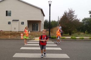 Now that school is in full swing, local law enforcement agencies are urging drivers to be aware of young pedestrians and cyclists on their way to school. Here, two Grass Valley Elementary crossing guards help a student get through an intersection safely.